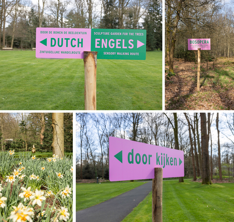 Door de bomen de beeldentuin